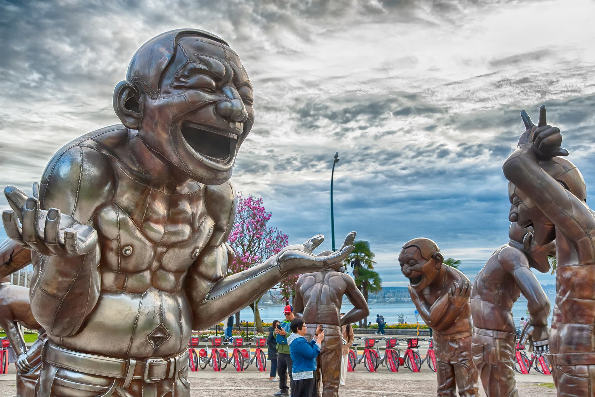 https://images.dailyhive.com/20250410150025/english-bay-laughing-statues.jpg